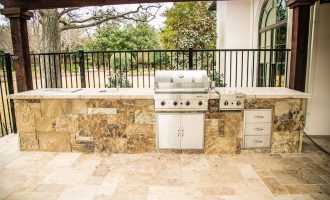 built in kitchen, iron fence and travertine installation in dallas